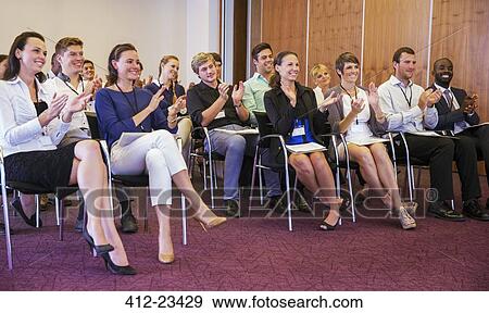 Business people watching presentation in conference room, clapping hands and smiling View Large Photo Image Stock Photo - Business people watching presentation in conference room, clapping hands and smiling. Fotosearch