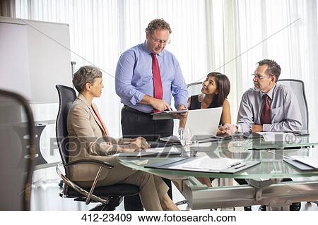 Businessman giving presentation during business meeting View Large Photo Image Stock Photo - Businessman giving presentation during business meeting. Fotosearch