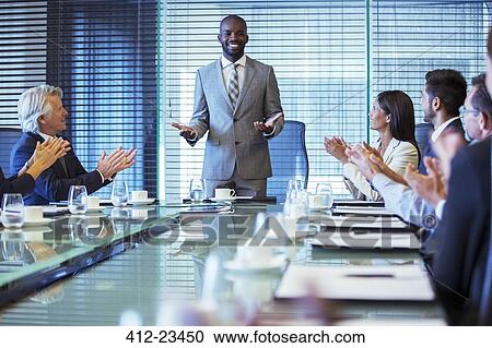 Businessman giving speech in conference room, colleagues clapping hands View Large Photo Image Stock Image - Businessman giving speech in conference room, colleagues clapping hands. Fotosearch