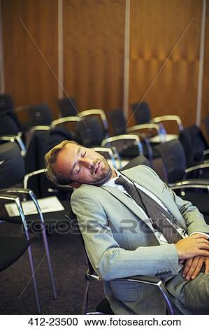 Businessman sleeping in conference room View Large Photo Image Stock Image - Businessman sleeping in conference room. Fotosearch