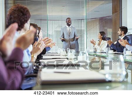 Businessman standing in conference room giving speech, colleagues clapping hands View Large Photo Image Stock Image - Businessman standing in conference room giving speech, colleagues clapping hands. Fotosearch