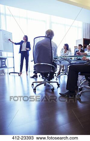 Businesswoman giving presentation in conference room View Large Photo Image Stock Image - Businesswoman giving presentation in conference room. Fotosearch