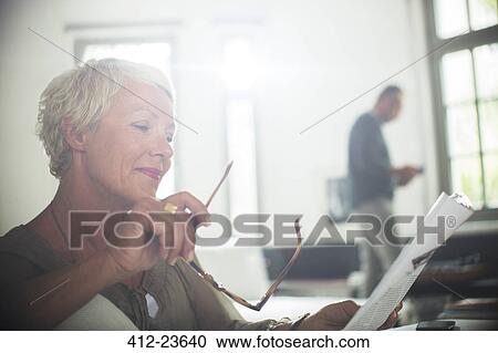 Businesswoman reading paperwork View Large Photo Image Stock Image - Businesswoman reading paperwork. Fotosearch