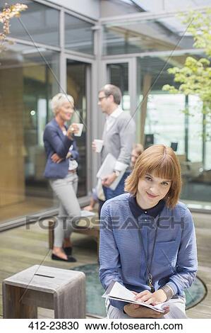 Businesswoman smiling in courtyard View Large Photo Image Stock Image - Businesswoman smiling in courtyard. Fotosearch