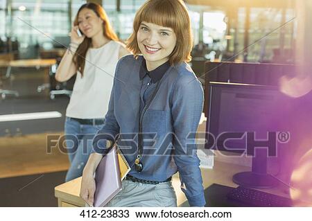 Businesswoman smiling in office View Large Photo Image Stock Image - Businesswoman smiling in office. Fotosearch