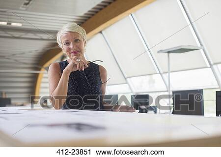 Businesswoman smiling in office View Large Photo Image Stock Image - Businesswoman smiling in office. Fotosearch