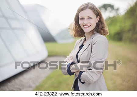 Stock Image - Businesswoman smiling outdoors. Fotosearch