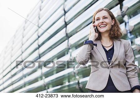 Businesswoman talking on cell phone outdoors View Large Photo Image Stock Image - Businesswoman talking on cell phone outdoors. Fotosearch