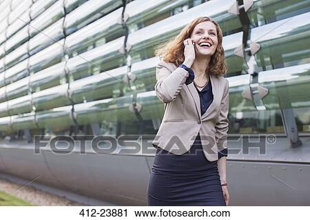 Businesswoman talking on cell phone outdoors View Large Photo Image Stock Image - Businesswoman talking on cell phone outdoors. Fotosearch