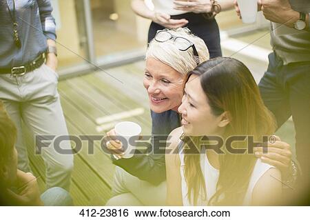 Businesswomen smiling in courtyard View Large Photo Image Stock Photograph - Businesswomen smiling in courtyard. Fotosearch