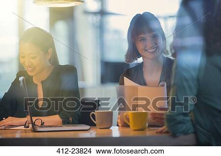 Picture - Businesswomen talking in office meeting. Fotosearch
