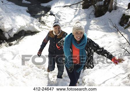 Couple climbing in snow View Large Photo Image Stock Photo - Couple climbing in snow. Fotosearch