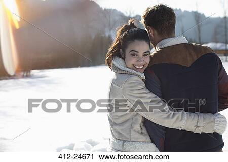 Couple hugging in snow View Large Photo Image Stock Image - Couple hugging in snow. Fotosearch