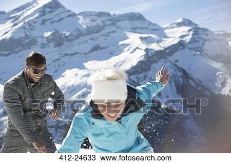 Couple playing in snow View Large Photo Image Stock Image - Couple playing in snow. Fotosearch