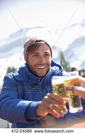 couple toasting beer glasses outdoors View Large Photo Image Stock Photo - couple toasting beer glasses outdoors. Fotosearch