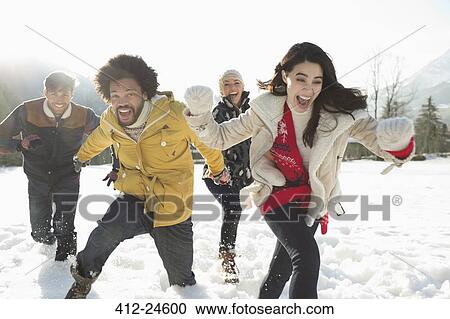 Couples running in snow View Large Photo Image Stock Image - Couples running in snow. Fotosearch
