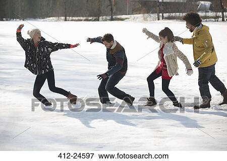 Couples walking in snow View Large Photo Image Stock Photo - Couples walking in snow. Fotosearch