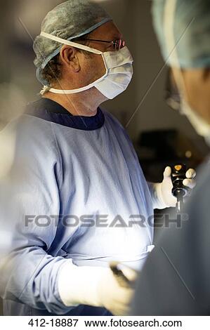 Doctor performing laparoscopic surgery in operating theater View Large Photo Image Stock Photo - Doctor performing laparoscopic surgery in operating theater. Fotosearch