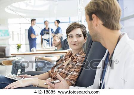 Doctor talking to patient undergoing medical treatment in outpatient clinic View Large Photo Image Stock Photography - Doctor talking to patient undergoing medical treatment in outpatient clinic. Fotosearch