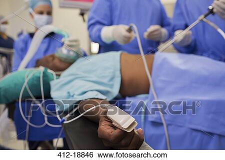 Doctors performing laparoscopic surgery, patient with pulse oxymeter on finger View Large Photo Image Stock Photograph - Doctors performing laparoscopic surgery, patient with pulse oxymeter on finger. Fotosearch