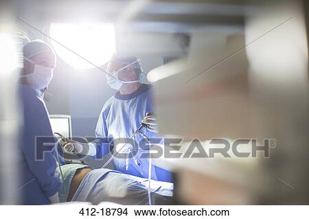 Doctors performing laparoscopic surgery in operating theater View Large Photo Image Picture - Doctors performing laparoscopic surgery in operating theater. Fotosearch
