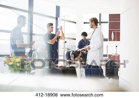 Doctors taking care of patients undergoing medical treatment in outpatient clinic View Large Photo Image Stock Photo - Doctors taking care of patients undergoing medical treatment in outpatient clinic. Fotosearch