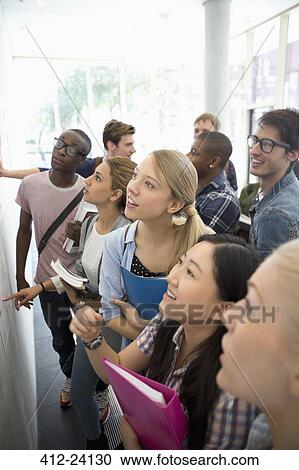 Elevated view of group of students looking at notice board during break View Large Photo Image Stock Image - Elevated view of group of students looking at notice board during break. Fotosearch
