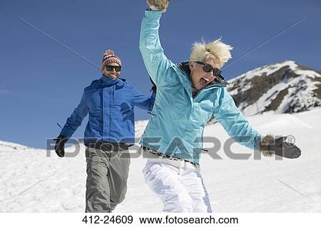 Exuberant couple playing in snow View Large Photo Image Stock Photo - Exuberant couple playing in snow. Fotosearch