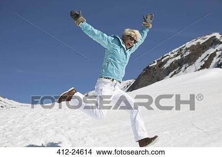 Exuberant woman playing in snow View Large Photo Image Picture - Exuberant woman playing in snow. Fotosearch