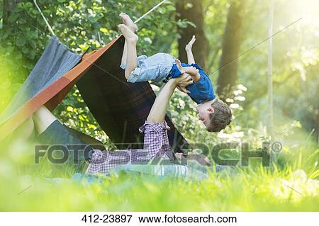Father and son playing near camping tent View Large Photo Image Stock Photo - Father and son playing near camping tent. Fotosearch