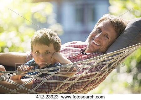 Father and son relaxing in hammock View Large Photo Image Stock Image - Father and son relaxing in hammock. Fotosearch