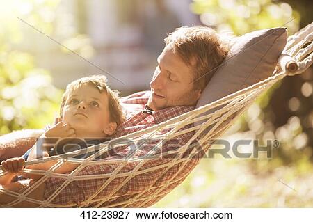Father and son relaxing in hammock View Large Photo Image Stock Photo - Father and son relaxing in hammock. Fotosearch