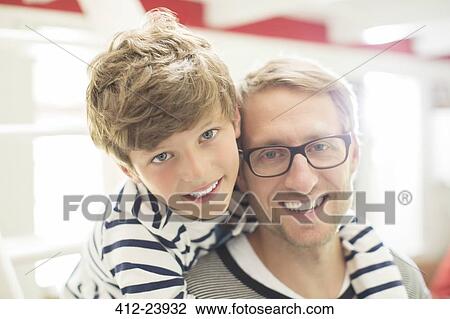 Stock Image - Father and son smiling. Fotosearch