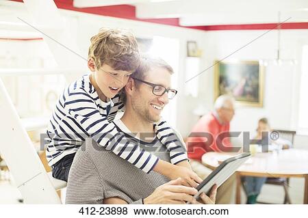 Father and son using digital tablet View Large Photo Image Stock Photo - Father and son using digital tablet. Fotosearch