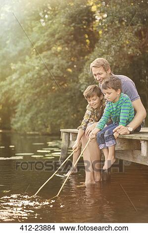 Father and sons fishing in lake View Large Photo Image Picture - Father and sons fishing in lake. Fotosearch