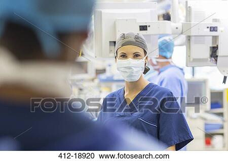 Female doctor wearing surgical cap and mask looking at camera View Large Photo Image Stock Image - Female doctor wearing surgical cap and mask looking at camera. Fotosearch