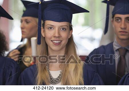 Stock Image - Female student in graduation clothes smiling at camera. Fotosearch