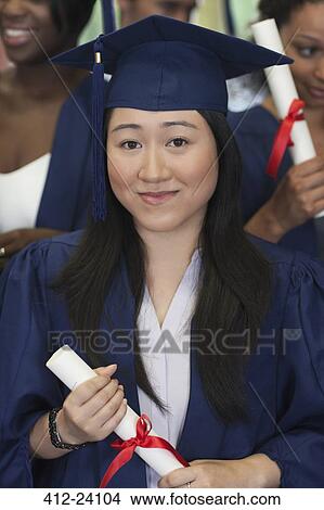 Female student smiling at camera and holding diploma View Large Photo Image Picture - Female student smiling at camera and holding diploma. Fotosearch
