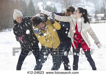 Friends enjoying snowball fight View Large Photo Image Stock Image - Friends enjoying snowball fight. Fotosearch