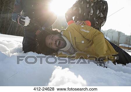Stock Photo - Friends enjoying snowball fight. Fotosearch