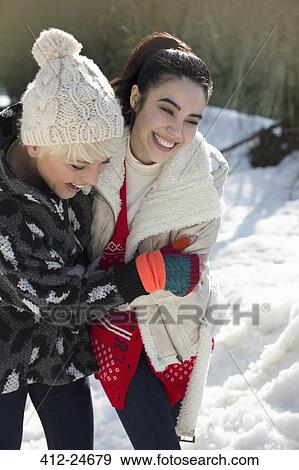 Friends hugging in snow View Large Photo Image Stock Photo - Friends hugging in snow. Fotosearch