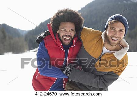 Friends laughing in snow View Large Photo Image Stock Image - Friends laughing in snow. Fotosearch