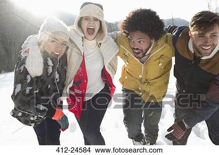 Friends playing in snow View Large Photo Image Picture - Friends playing in snow. Fotosearch