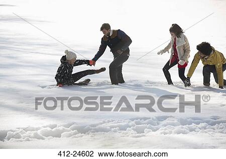 Stock Image - Friends playing in snow. Fotosearch