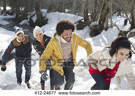 Friends playing in snow View Large Photo Image Stock Photo - Friends playing in snow. Fotosearch