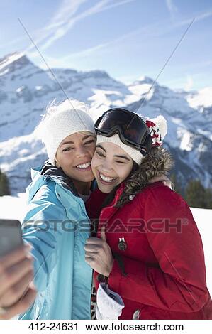 Friends taking selfie in snow View Large Photo Image Stock Image - Friends taking selfie in snow. Fotosearch