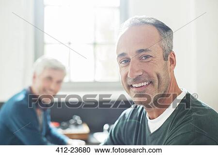 Gay couple relaxing together View Large Photo Image Stock Image - Gay couple relaxing together. Fotosearch