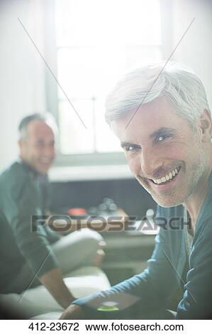 Gay couple relaxing together with record player View Large Photo Image Stock Image - Gay couple relaxing together with record player. Fotosearch