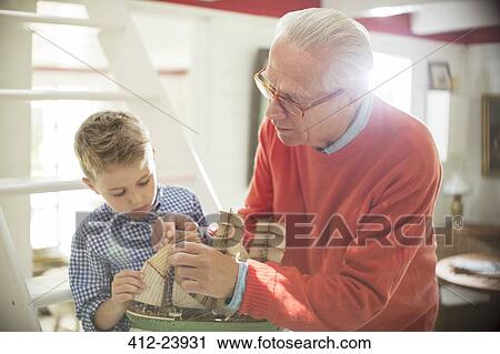 Grandfather and grandson building model sailboat View Large Photo Image Stock Image - Grandfather and grandson building model sailboat. Fotosearch