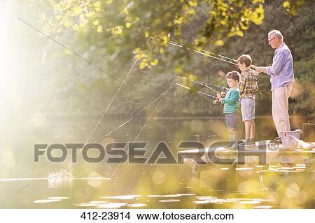 Grandfather and grandsons fishing at lake View Large Photo Image Picture - Grandfather and grandsons fishing at lake. Fotosearch